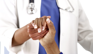 EMS-doctor-holding-patient-hand-edited